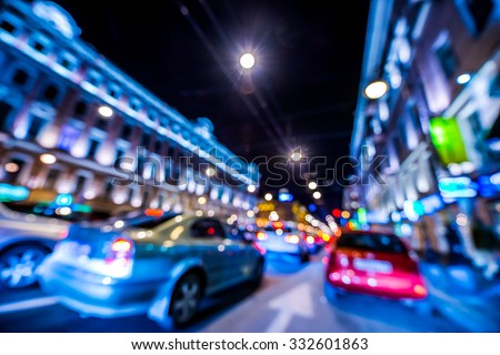 Nights lights of the big city, rush hour in the city. Wide-angle view, defocused image, in blue tones