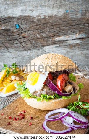Close up of home made burgers on wooden background