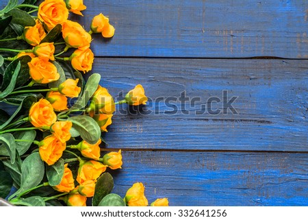 Orange roses flowers on rustic wood background. Flowers backgrounds.