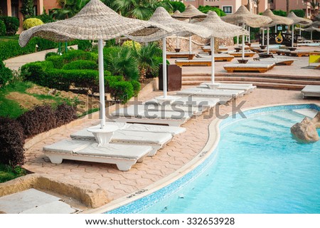 Summer outdoor swimming pool and sun loungers. In the hotel to rest.