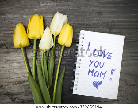 tulip bouquet and notepad with words "I love you mom"