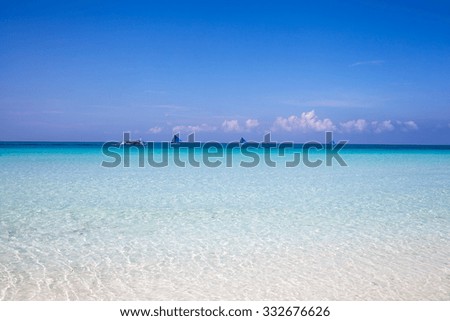 Tropical landscape with turquoise sea and white sandy beach and boat, boracay, philippines 