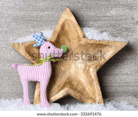 Snowy wooden star with reindeer.