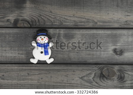 New culinary biscuit on wooden background and the background of green fur-tree covered with snow - Your text or picture top view