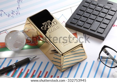 Gold bullion bar on a stocks and shares chart 