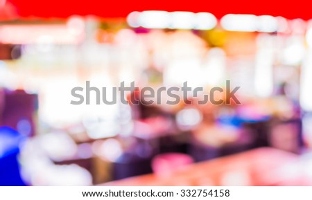 image of blur people at food stall with bokeh ; vintage tone for background usage .