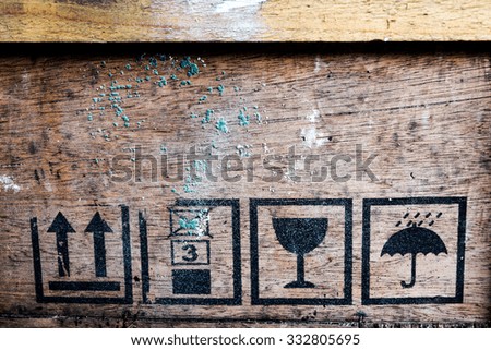 Fragile symbol on old wood board.