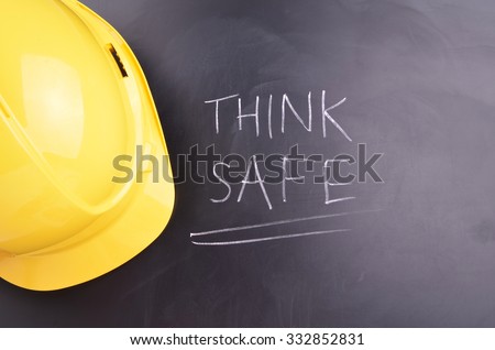 Work Place Safety Concept with safety equipment and a blackboard in the background