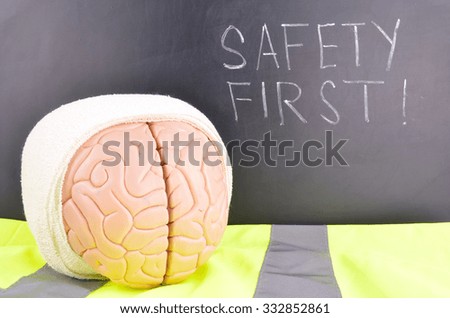 Work Place Safety Concept with safety equipment and a blackboard in the background