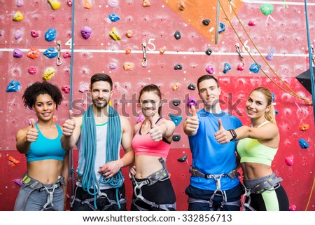 Fit people getting ready to rock climb at the gym
