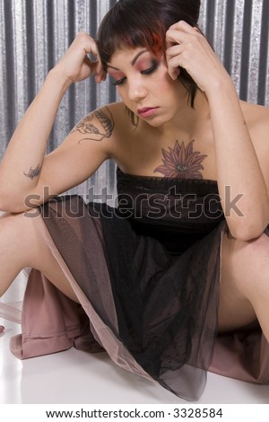Sad woman with unusual tattoos.