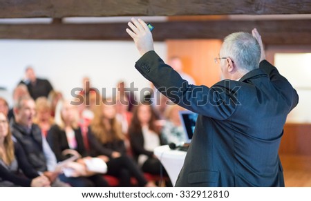 Speaker at Business Conference with Public Presentations. Audience at the conference hall. Rear view. Horisontal composition. Background blur. Royalty-Free Stock Photo #332912810