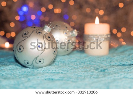 Christmas balls and candles. Christmas card. 
Shallow depth of field. Focus on the front ball