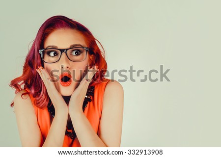 Wow. Close up portrait young woman beautiful girl with long red hair looking excited holding her mouth opened, hands on head, isolated green wall. Shocked surprised stunned. Positive human emotion Royalty-Free Stock Photo #332913908