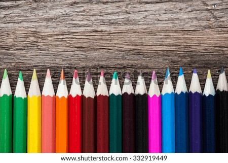 Color pencils on wooden background