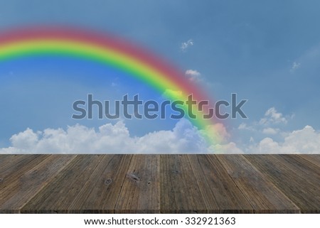 Wood terrace and Blue sky and white cloud with rainbow