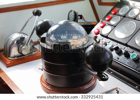big compass on a boat showing direction on daytime Royalty-Free Stock Photo #332925431
