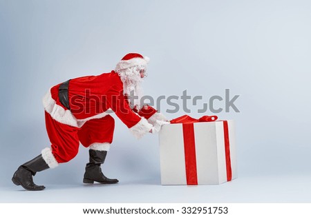Santa Claus and huge gift.