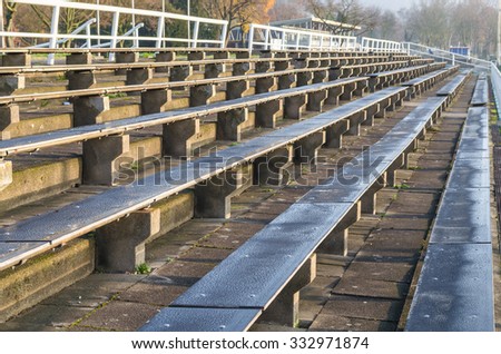 Old rows of seats, chairs, benches for a sporting event.