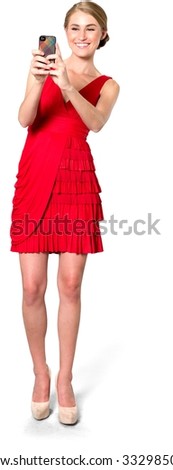 Excited Caucasian young woman with medium blond hair in evening outfit using mobile phone - Isolated