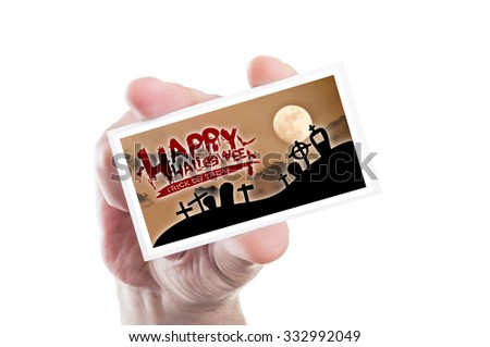 Hand holding happy Halloween and trick or treat card isolated on white background