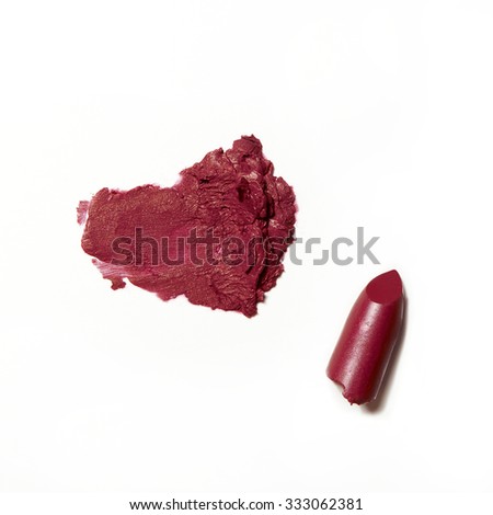 broken and smudge red fuchsia lipstick on white background