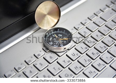 Navigation on the Internet! Photo of magnetic compass on computer keyboard.