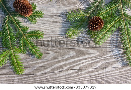 Christmas Background. Spruce branches with cones and texture of old wood frame Christmas background old wooden boards