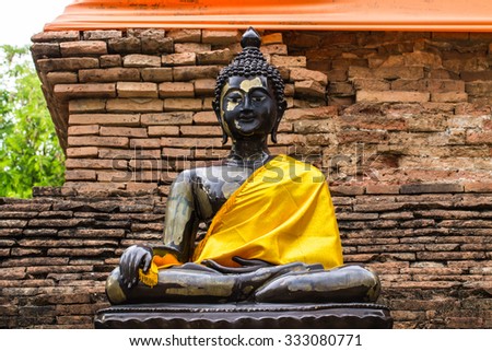 Black Buddha Statue and old chedi in Wat Lok mo lee , Chiangmai 