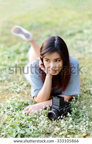 Happy Asian girl with vintage film camera