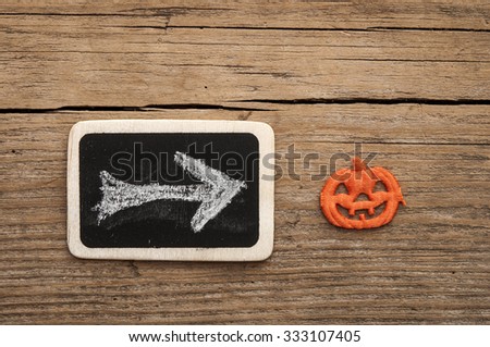 Halloween pumpkin over chalkboard.