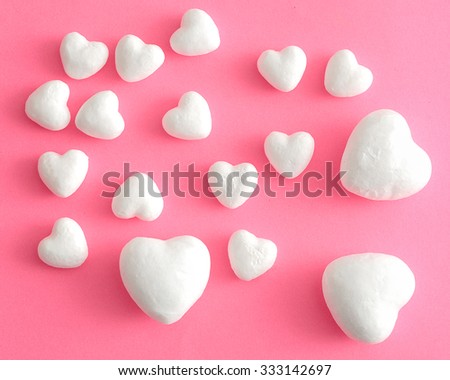 Valentine's Day. White polystyrene hearts on a pink background