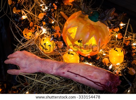 Selected focus Halloween pumpkin with candlelight and skull with bokeh background.