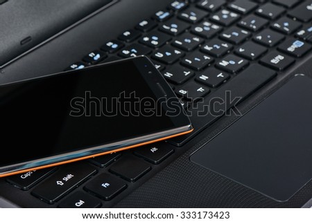 closeup of smartphone on a korean keypad of laptop
