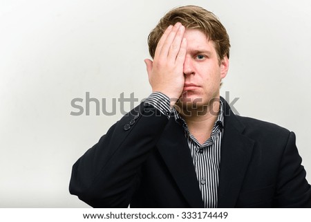 Portrait of businessman covering his eye