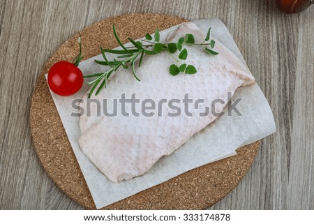 Raw duck breast with rosemary - ready for cooking