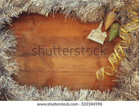 image of christmas festive decorations on wooden background. retro filtered