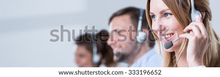 Service desk consultant talking on hands-free phone Royalty-Free Stock Photo #333196652