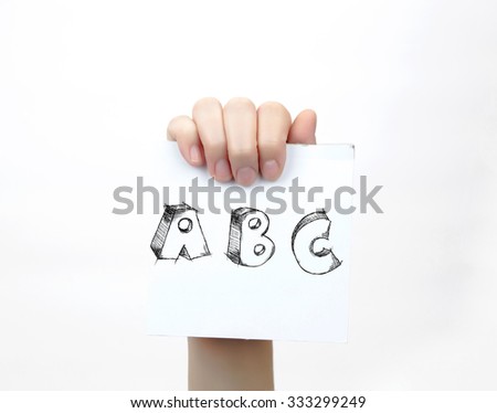 Hand holding a piece of paper with sketchy capital letters ABC, isolated on white.