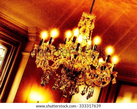 Chandelier hanging from ceiling with lights on