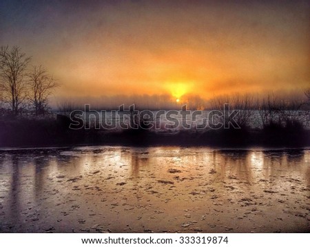 Sunrise over frozen Leeds and Liverpool canal near Wigan