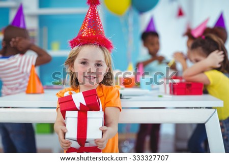 Smiling girl at birthday party with presents