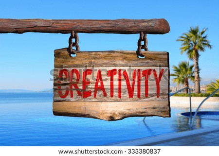 Creativity motivational phrase sign on old wood with blurred background