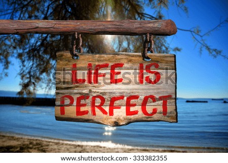 Life is perfect motivational phrase sign on old wood with blurred background