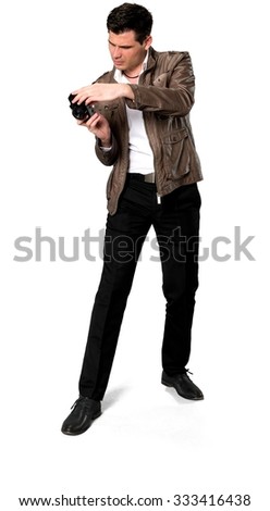 Serious Caucasian man with short dark brown hair in casual outfit using camera - Isolated