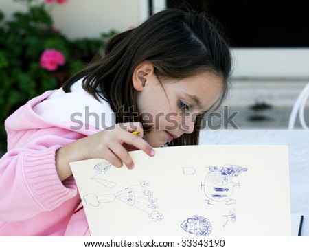 a caucasian child doing her homework in the garden