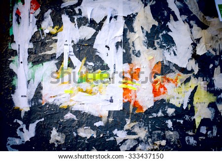Old advertisement Board, abstract background. Snatches of old ads and posters on a concrete wall