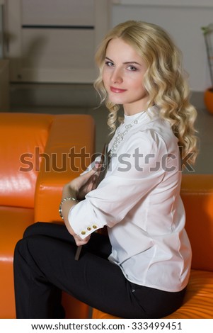 portrait of a cute girl realtor in office