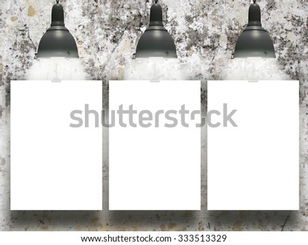 Three hanged paper sheet frames with retro lamps on moulded concrete wall background