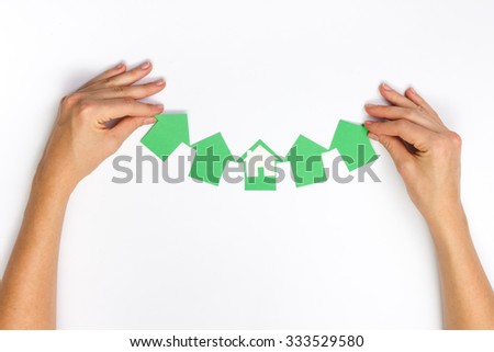 Paper house figure and blank business card on wooden background. Real Estate Concept. Top view.